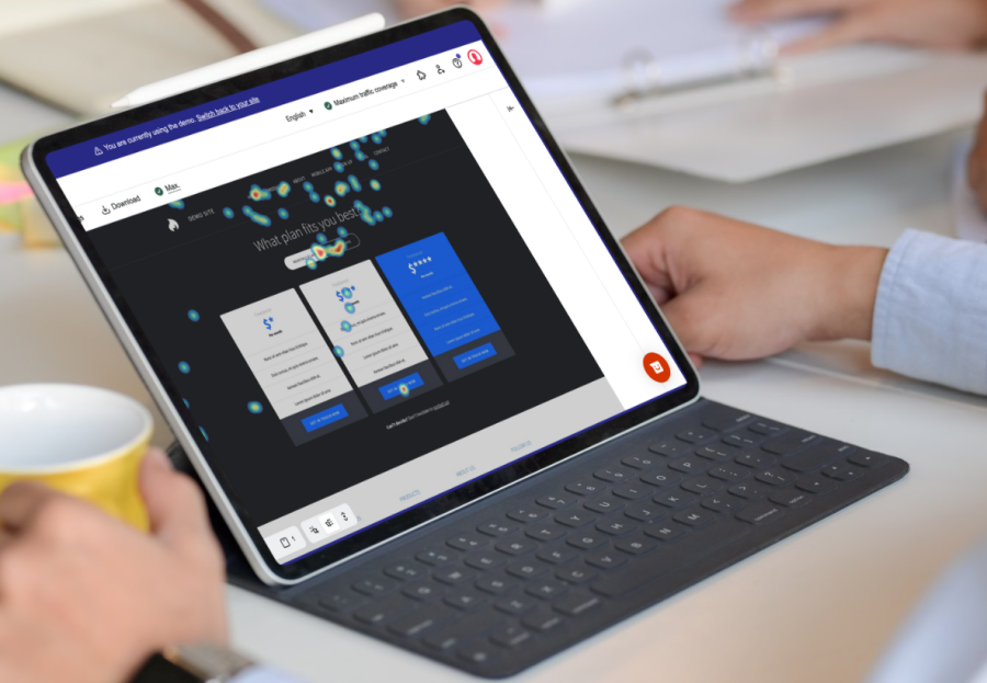 Looking over the shoulder of a man, there is a computer tablet screen showing a heatmap from the hotjar app. This presents qualitative data to learn from.
